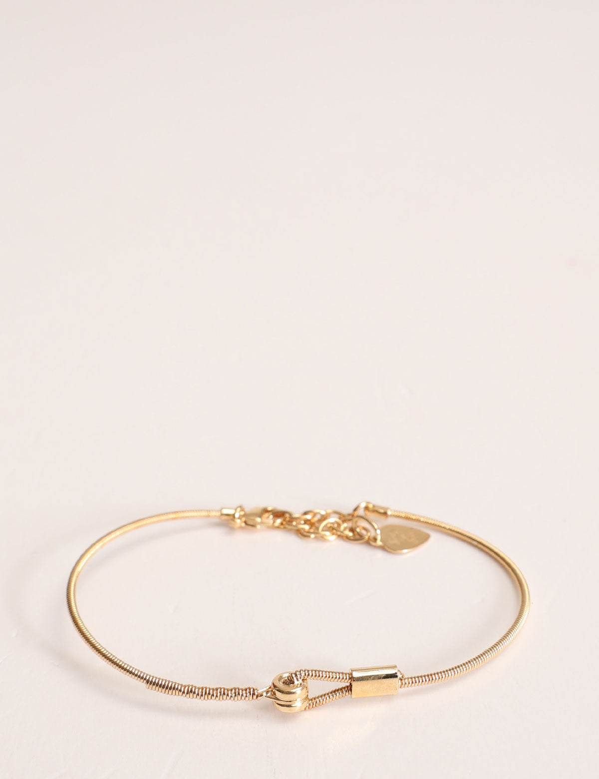 Horizontal Sing a Song bracelet in yellow gold guitar string